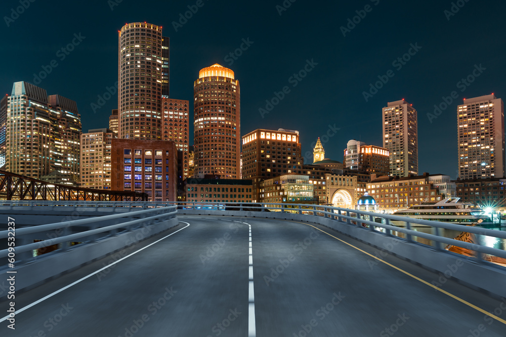 Empty urban asphalt road exterior with city buildings background. New modern highway concrete construction. Concept of way to success. Transportation logistic industry fast delivery. Boston. USA. Empty urban asphalt road exterior with city buildings background. New modern highway concrete construction. Concept of way to success. Transportation logistic industry fast delivery. Boston. USA.