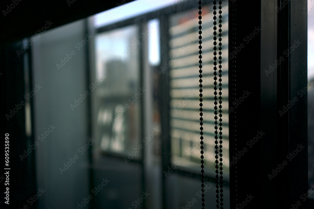 close up of chains used to pull the blinds curtain