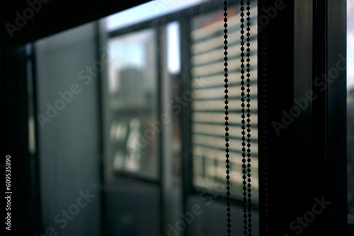 close up of chains used to pull the blinds curtain