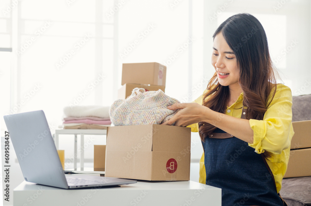 Small business owner packing in the cardbox at home office. Woman preparing a parcel for delivery at online selling business office. Entrepreneurs Arranging Goods With Parcel Boxes Startup Ideas. Small business owner packing in the cardbox at home office. Woman preparing a parcel for delivery at online selling business office. Entrepreneurs Arranging Goods With Parcel Boxes Startup Ideas.