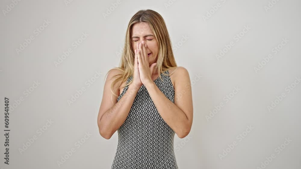 Young blonde woman sneezing over isolated white background Young blonde woman sneezing over isolated white background
