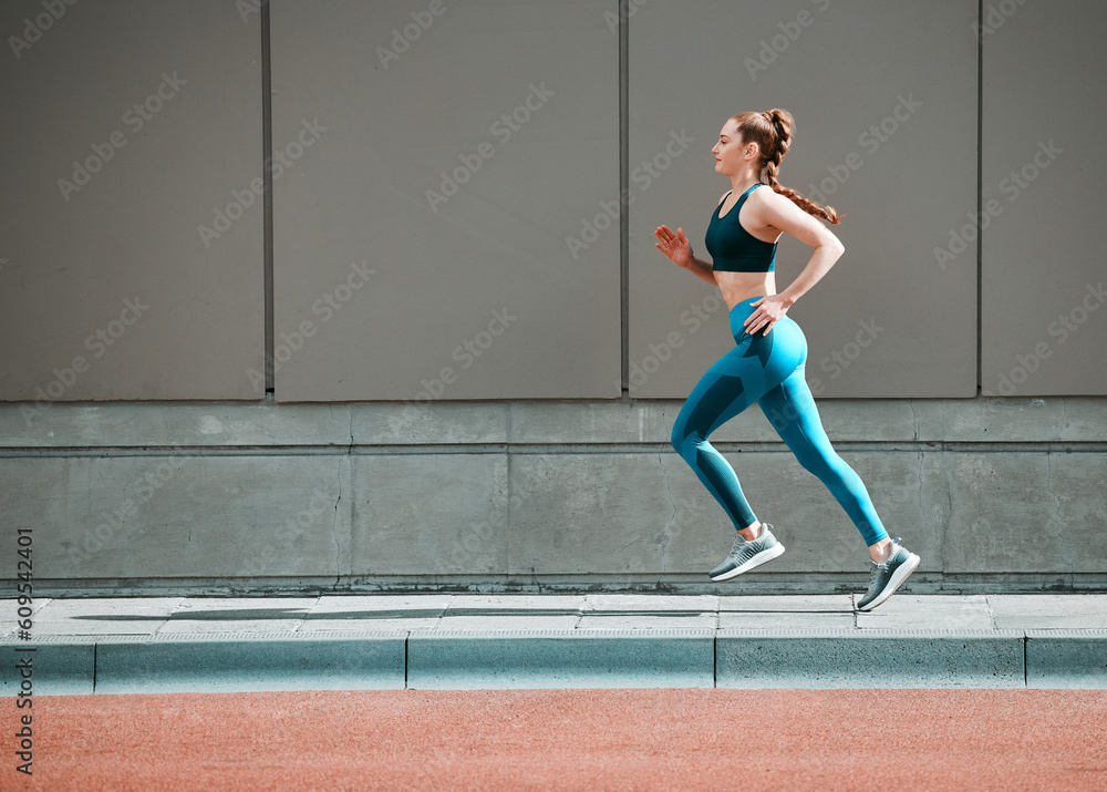 Fototapeta premium Young woman, urban running and city sidewalk with training, exercise and fitness on road. Street, runner profile and female athlete with mockup and body workout for health, wellness and race outdoor