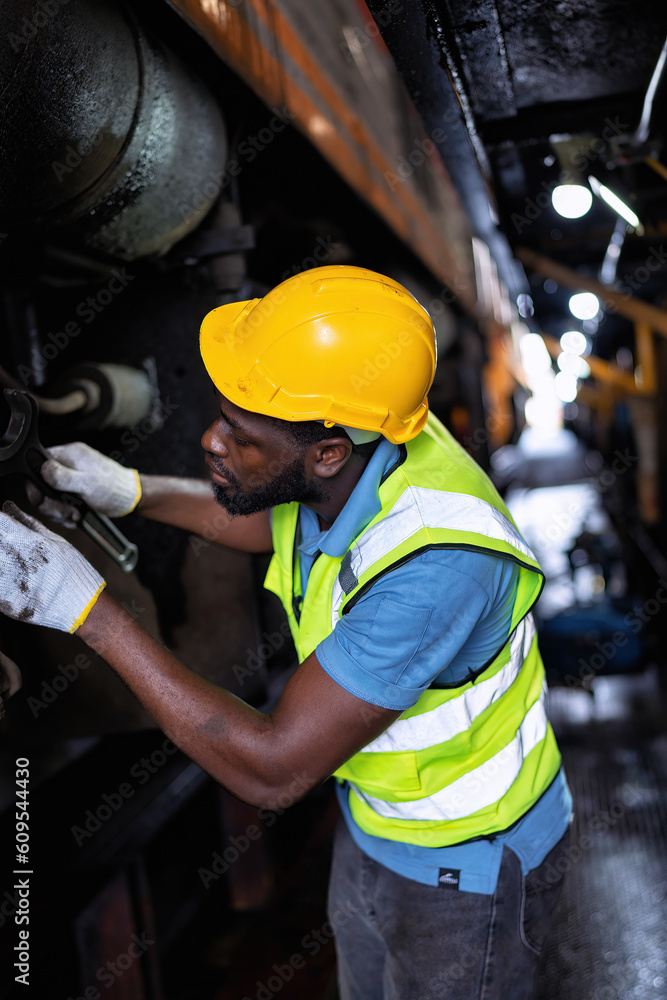 Engineer railway wearing safety gear checking train transmittal system for safety travel passenger Engineer railway wearing safety gear checking train transmittal system for safety travel passenger