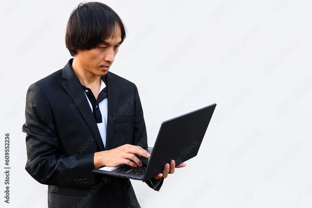 Asian business man standing use laptop in his hand Asian business man standing use laptop in his hand