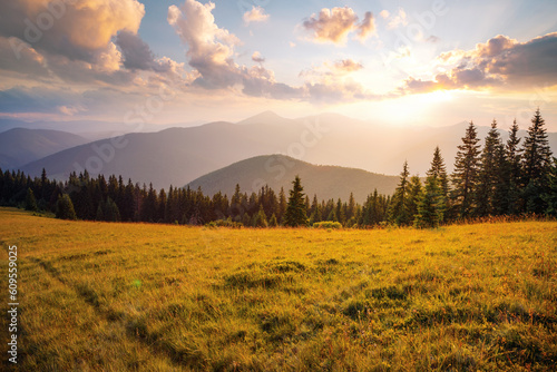 Majestic view of the mountain ranges illuminated by the sun's rays. Carpathian mountains, Ukraine.