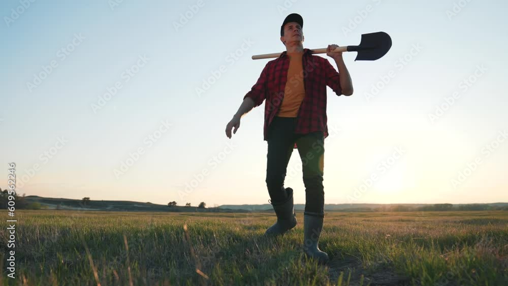 custom made wallpaper toronto digitalMale farmer walking through green field with shovel. Farmer agronomist works in field at sunset. Agricultural business concept. Farmer's work in field. work of man of countryside.