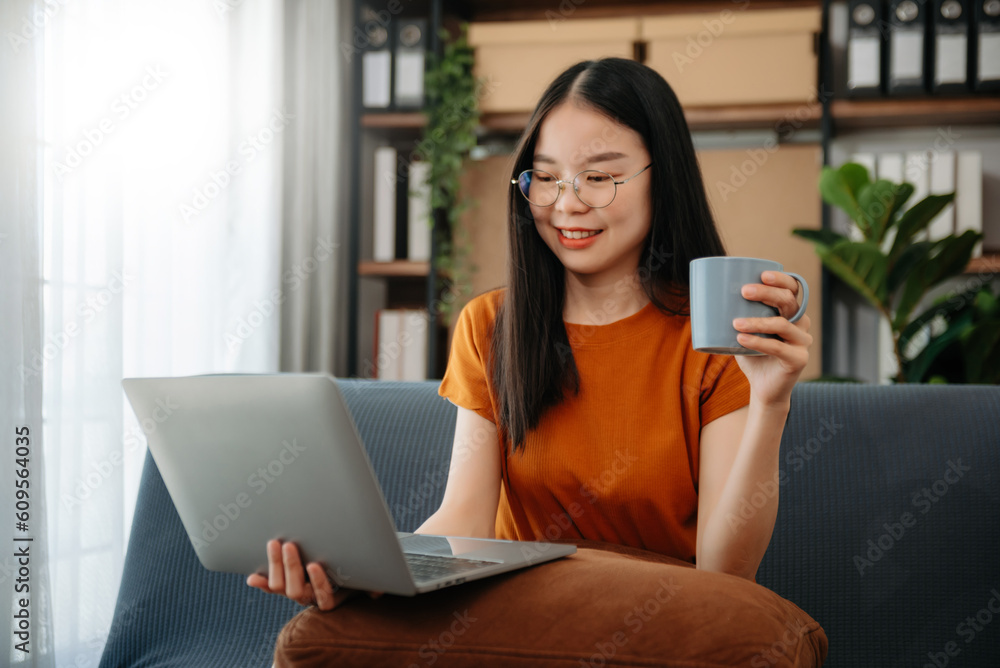 Asian woman using the smartphone and tablet on the sofa at home. Asian woman using the smartphone and tablet on the sofa at home.