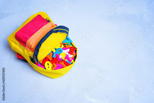 Small Vibrant Backpack Stuffed with Colorful Wooden Letters
