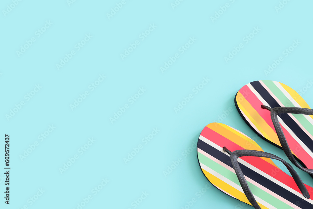 vacation and summer image with colorful flipflops over blue background vacation and summer image with colorful flipflops over blue background