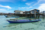 Small boats moored at the edge of a nomadic Bajau Laut village on the edge of an island in Semporna, Malaysia waters