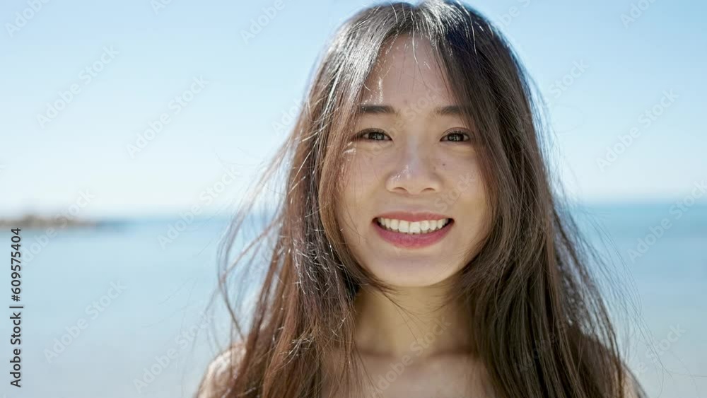 Young chinese woman smiling confident standing at seaside Young chinese woman smiling confident standing at seaside