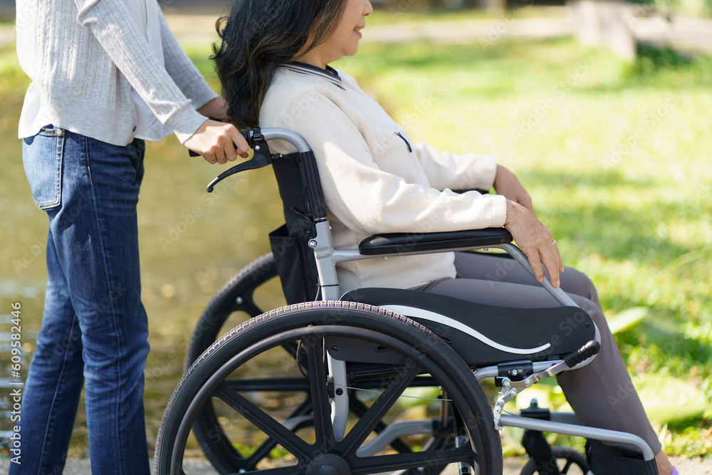 Nursing home. Young caregiver helping senior woman in wheelchair. Nursing home. Young caregiver helping senior woman in wheelchair.