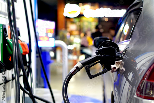 Car parked at gas station Refuel your car with gasoline or diesel with a fuel dispenser.