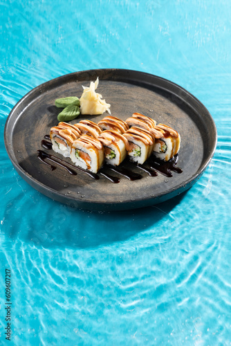 japanese cuisine sushi rolls on blue water background