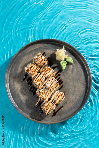 japanese cuisine sushi rolls on blue water background