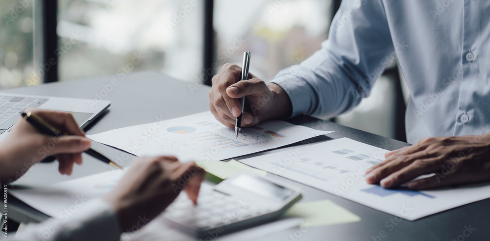 businessman or accountant hand working on calculator to calculate business data, accounting document and laptop computer at office, business concept businessman or accountant hand working on calculator to calculate business data, accounting document and laptop computer at office, business concept