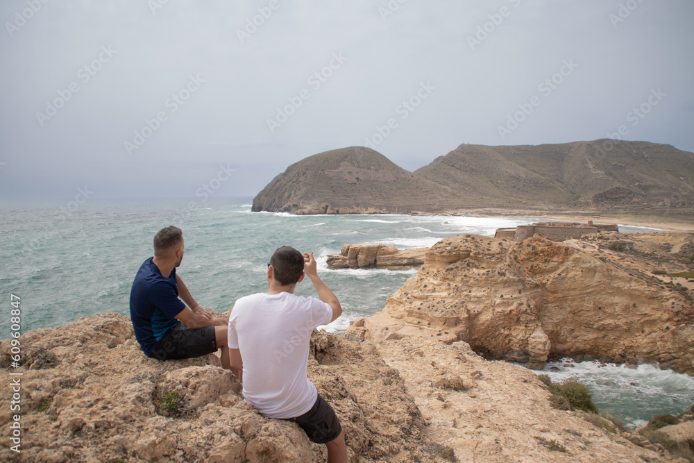 views from the cliffs of mediterranean sea with a castell and guys 