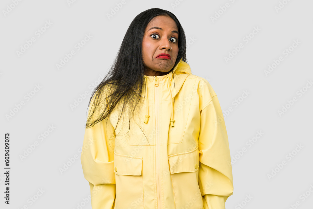 Young Indian woman cut out isolated on white background shrugs shoulders and open eyes confused. Young Indian woman cut out isolated on white background shrugs shoulders and open eyes confused.