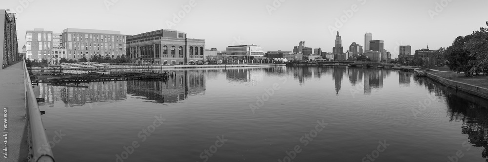 Fototapeta premium Panoramic Providence cityscape black and white retro style photo, with skyline and industrial buildings, tranquil water reflections, and the old Point Street Bridge over the river in Rhode Island 