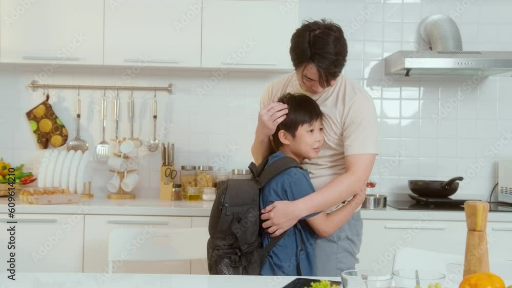 Happy Young Asian father encouraging to his son to go to school Happy Young Asian father encouraging to his son to go to school