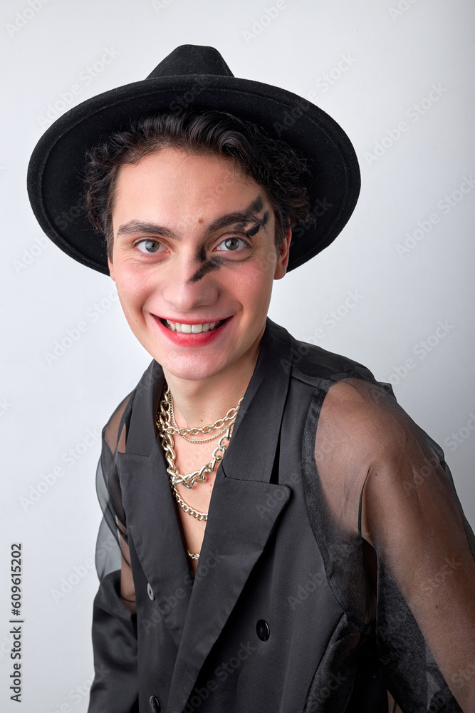 emotive excited gender 20s transgender gay man wearing necklace and hat, isolated on white background. handsome happy gay looking at camera and smiling. portrait. human emotions, people lifestyle