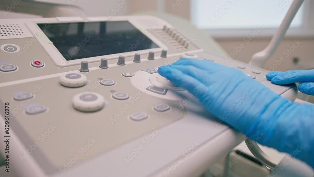 Transvaginal Machine A gynecologist uses a transvaginal ultrasound device presses buttons ...