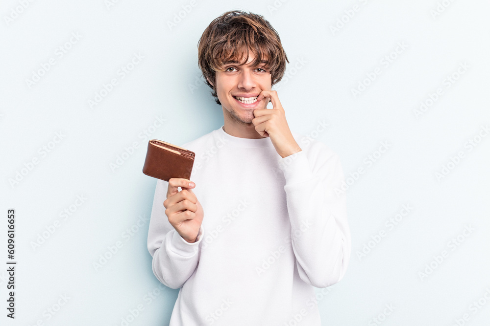 Young caucasian man holding a ballet isolated on blue background biting fingernails, nervous and very anxious. Young caucasian man holding a ballet isolated on blue background biting fingernails, nervous and very anxious.