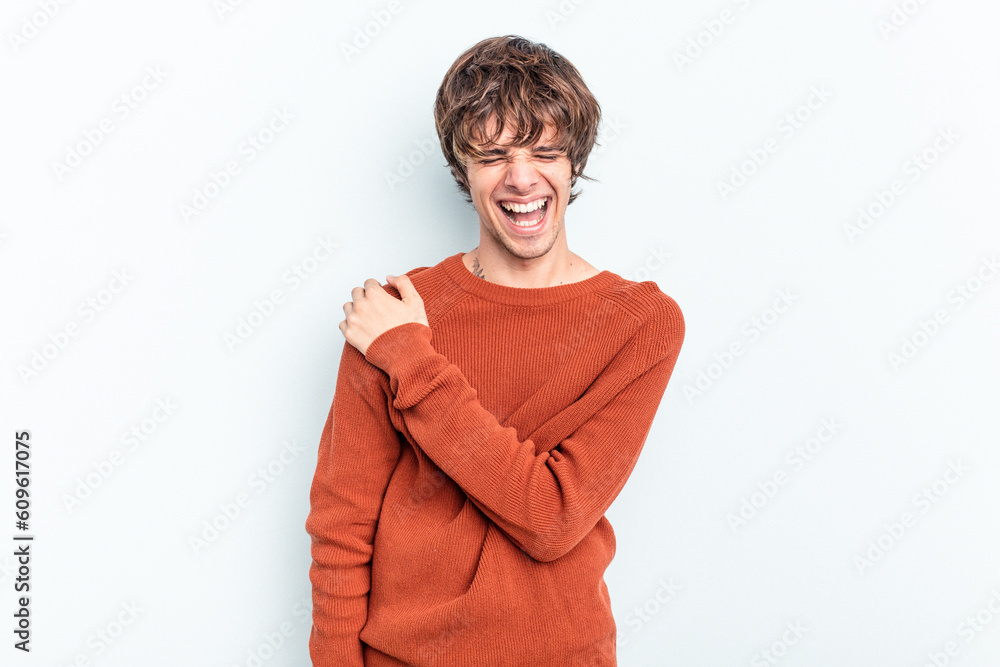 Young caucasian man isolated on blue background having a shoulder pain. Young caucasian man isolated on blue background having a shoulder pain.