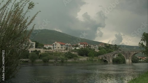 Beautiful view of the bridge Arslanagic with a hill during a thunderstorm photo
