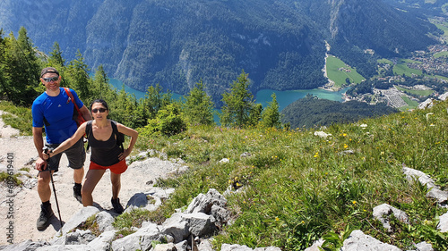Young Couple Hiking In The Swiss Alps with lake in the background