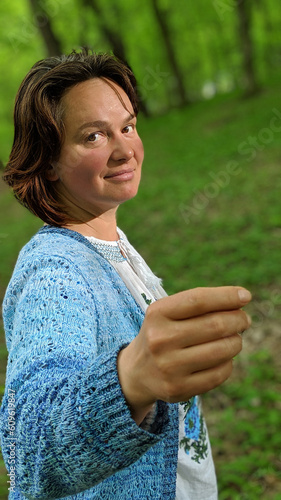 Portrait of adult woman holding an imaginary object in hand