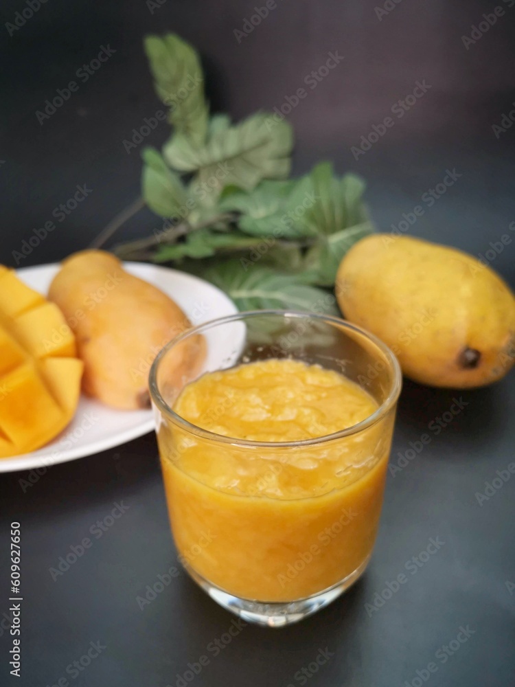 Mango smoothie on black background