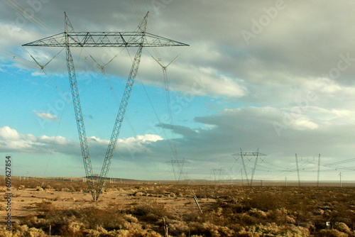 torres de cable de luz en el campo en rutas de la patagonia argentina, escena rural photo