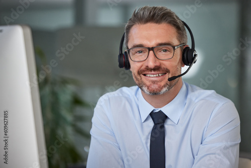 Businessman, call center and portrait smile in telemarketing, customer service or support at office. Happy man, consultant or agent smiling with headphones for online advice or telesales at workplace photo