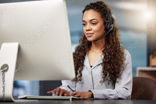 Call center, virtual assistant or woman typing on computer at telecom customer services office job help desk. Microphone, technology or female sales agent consulting or helping in tech support on pc photo