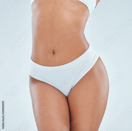 Fotografie Body, stomach and a woman with underwear for femininity isolated on a white background in studio