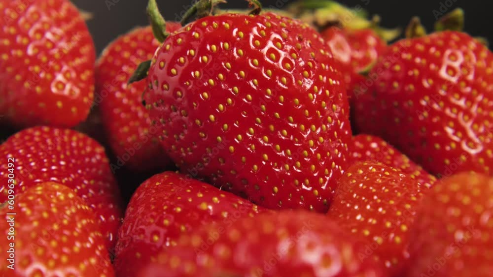 Macro shot of bright ripe red strawberries. The camera pans around. Juicy and appetising strawberries. Healthy and natural food concept Macro shot of bright ripe red strawberries. The camera pans around. Juicy and appetising strawberries. Healthy and natural food concept