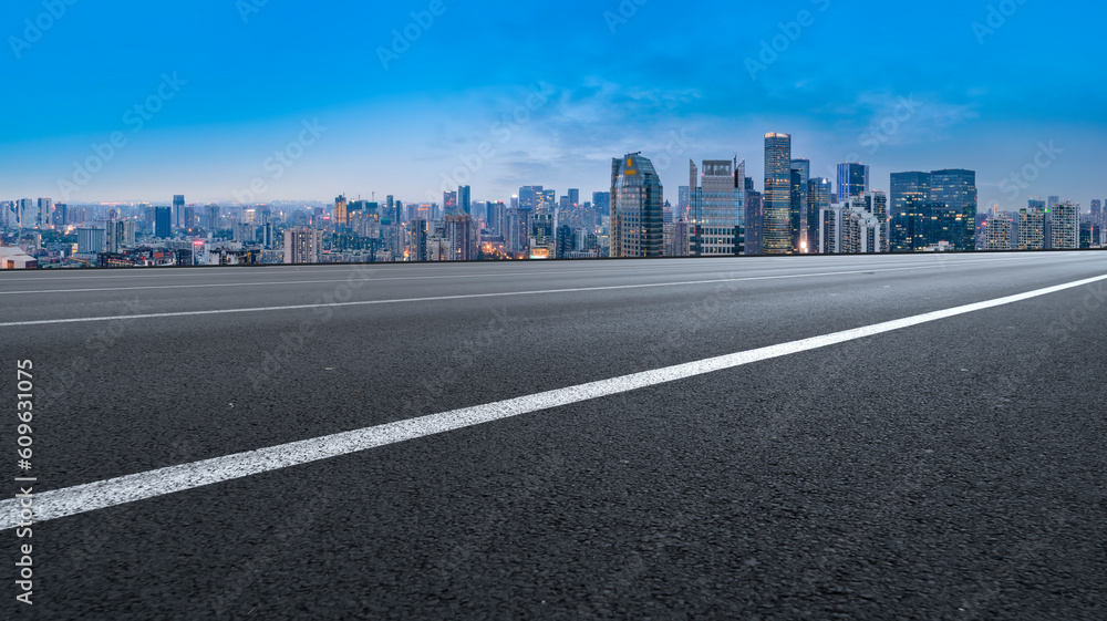 Asphalt pavement and urban building skyline