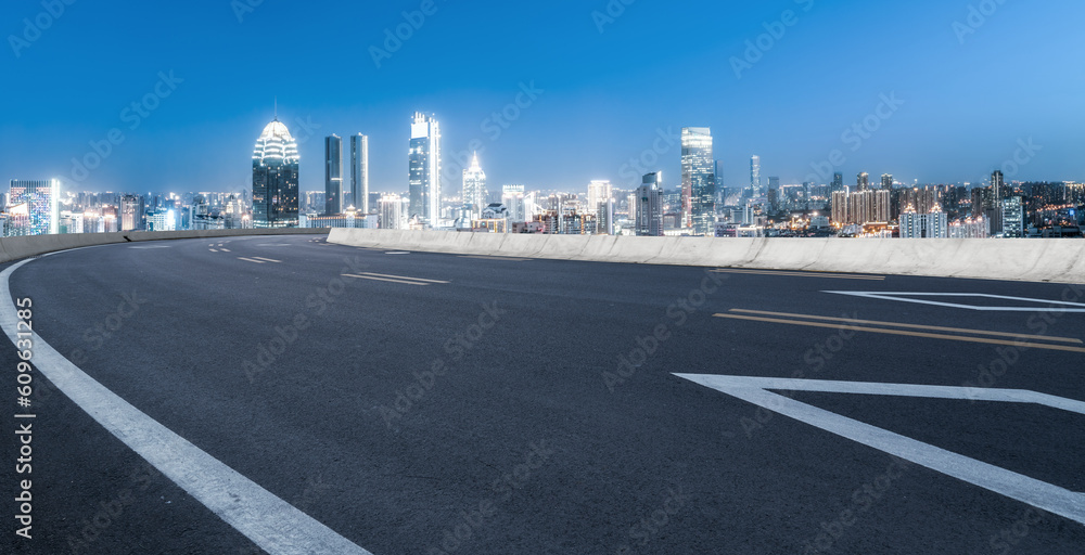 Asphalt pavement and urban building skyline