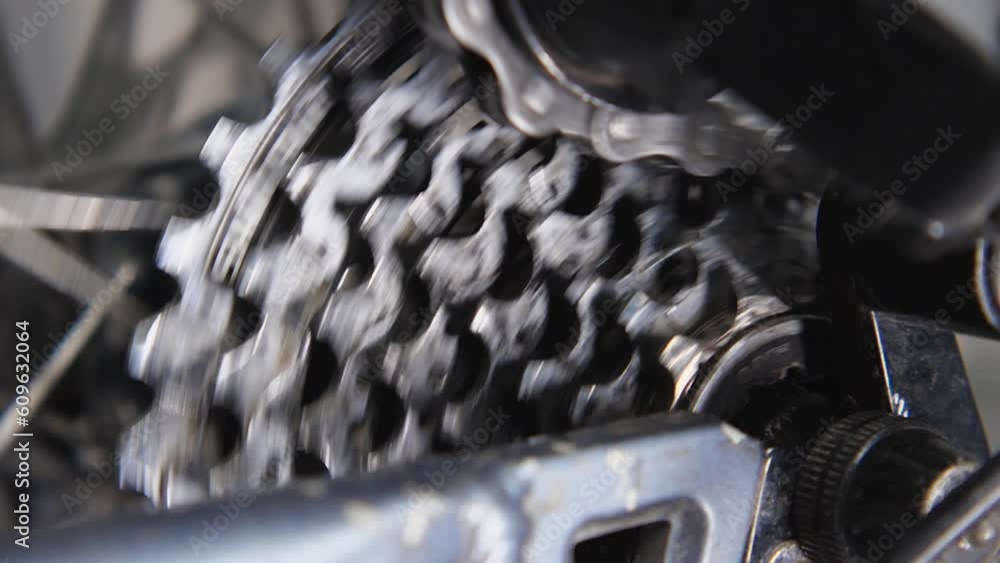 Close-up of a rotating bicycle cassette and the chain moving along it. Bicycle repair and maintenance workshop. Slow motion Close-up of a rotating bicycle cassette and the chain moving along it. Bicycle repair and maintenance workshop. Slow motion