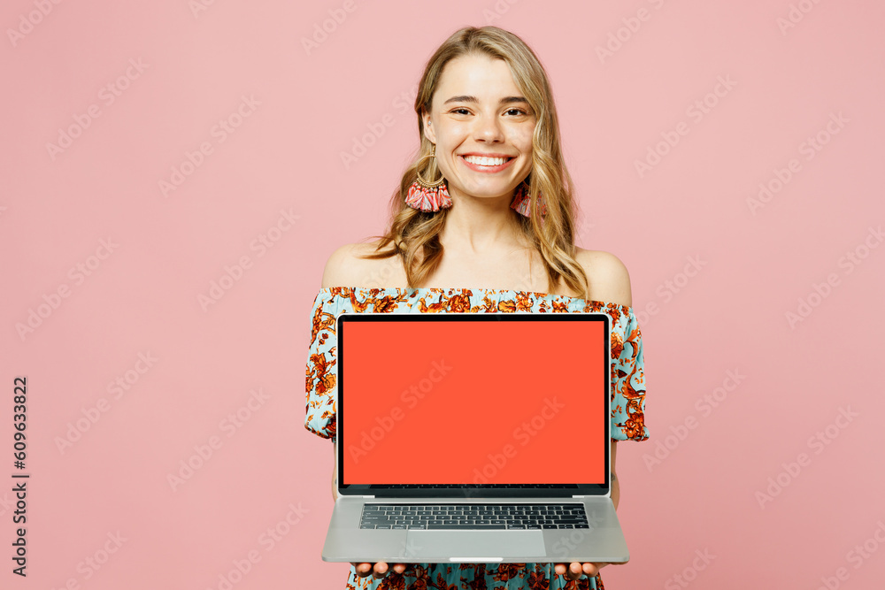 Young blonde IT woman wear summer casual clothes hold use work on laptop pc computer with blank screen workspace area isolated on plain pastel light pink background studio portrait. Lifestyle concept. Young blonde IT woman wear summer casual clothes hold use work on laptop pc computer with blank screen workspace area isolated on plain pastel light pink background studio portrait. Lifestyle concept.