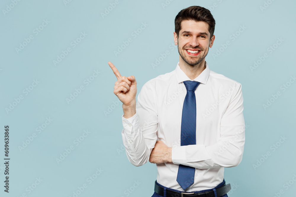 Young employee business man corporate lawyer wear classic formal shirt tie work in office point index finger aside on workspace area mock up isolated on plain pastel blue background studio portrait. Young employee business man corporate lawyer wear classic formal shirt tie work in office point index finger aside on workspace area mock up isolated on plain pastel blue background studio portrait.