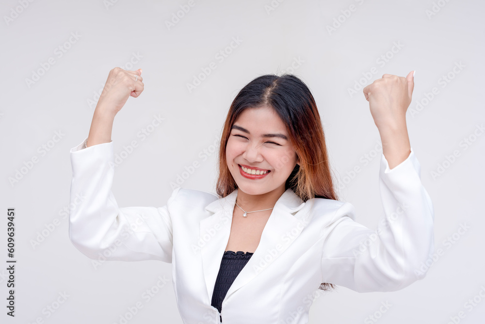 An optimistic and strong young woman raising her arms in excitement. Isolated on a white background. An optimistic and strong young woman raising her arms in excitement. Isolated on a white background.