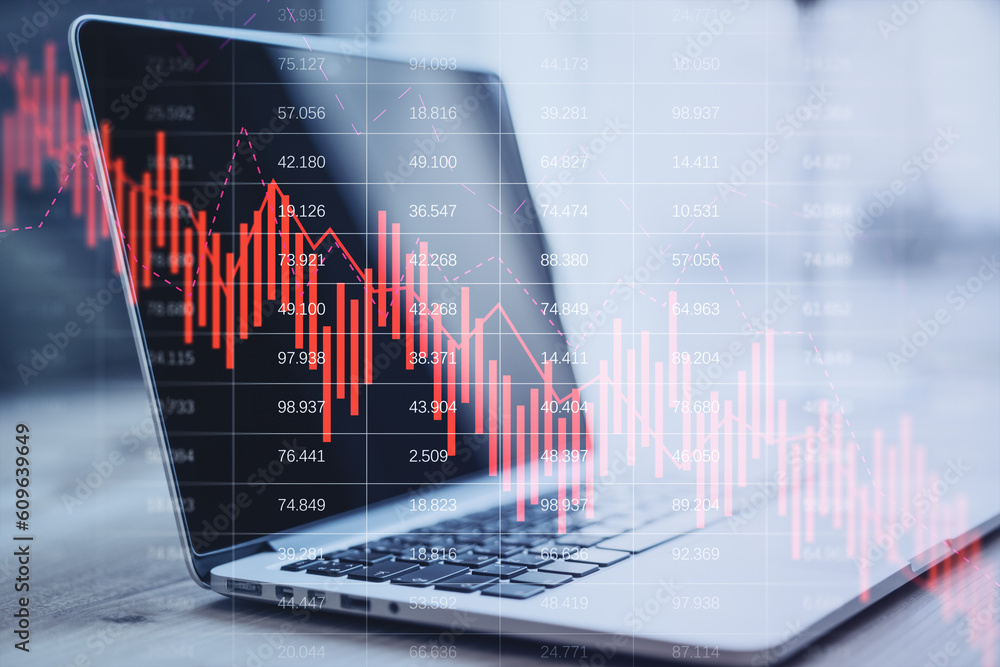 Close up of laptop on desktop with falling red business graph grid on blurry background. Crisis, recession and stock market concept. Double exposure. Close up of laptop on desktop with falling red business graph grid on blurry background. Crisis, recession and stock market concept. Double exposure.