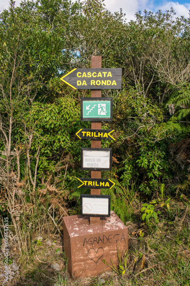 Signs pointing to Ronda Waterfall and hiking paths at the Ronda Municipal Natural Park in Sao Francisco de Paula, South of Brazil Signs pointing to Ronda Waterfall and hiking paths at the Ronda Municipal Natural Park in Sao Francisco de Paula, South of Brazil