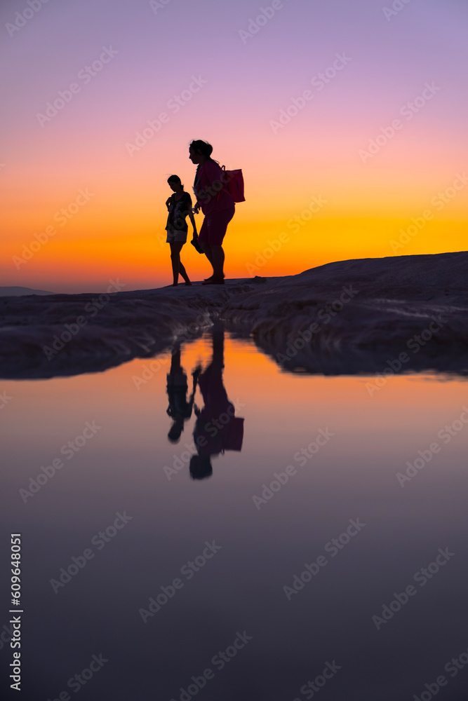 People walking by the lake at sunset, silhouette, Pamukkale - Turkey People walking by the lake at sunset, silhouette, Pamukkale - Turkey