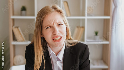 Annoying communication. Indignant expression. Confused disbelief. Irritated angry blond young business woman asking question leaning forward at office.