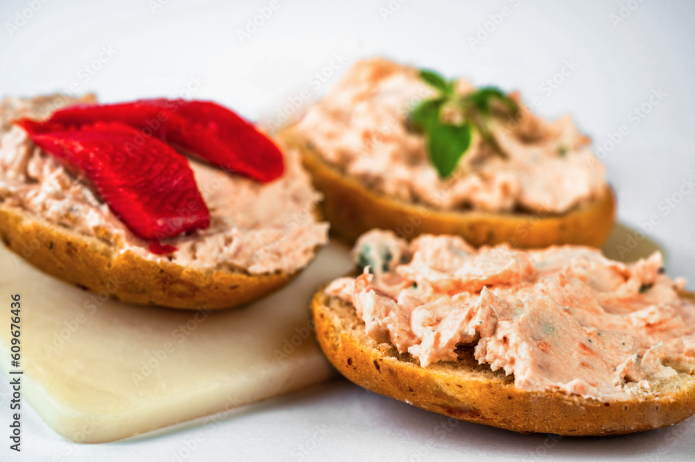 3 canapés with salmon spread with fresh cheese on board. 3 canapés with salmon spread with fresh cheese on board.