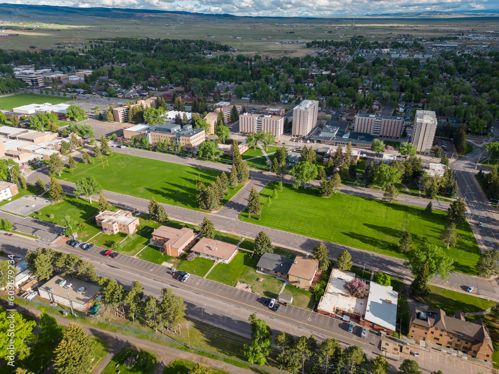 Grassy area of University campus with apartment buildings and houses aerial view