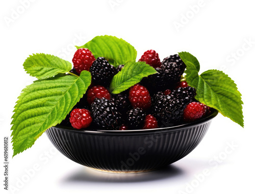 Dish of red and black mulberry with green leaves isolated on a white background